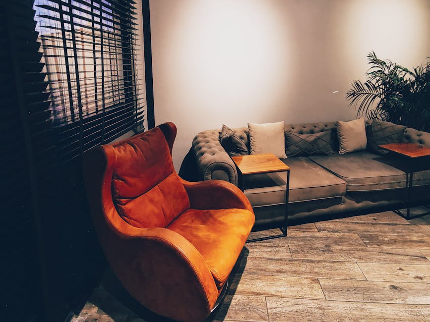 Chic living room interior featuring a modern armchair and plush sofa. Perfect for home decor inspiration.