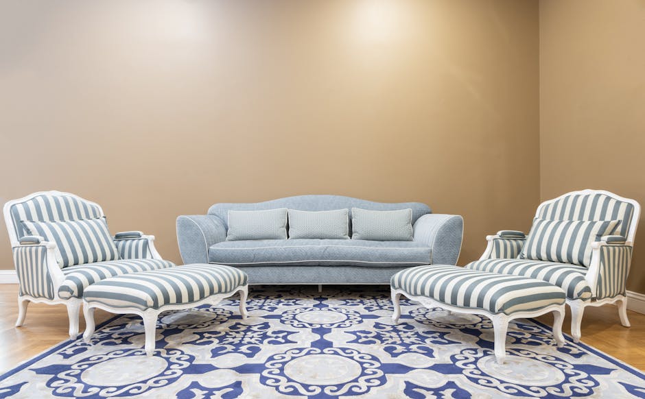 Beautiful living room interior with blue striped chairs, sofa, and ornate carpet.